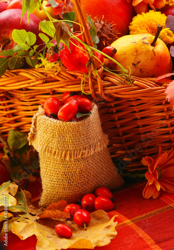 Photo: Wicker basket with autumn fruits and flowers Wicker basket with autumn fruits and flowers