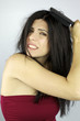 Beautiful woman trying to brush her messy hair
