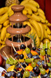 Photo: Dipping fruits into a Chocolate Fountain Dipping fruits into a Chocolate Fountain