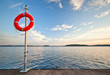 Bright red safe lifebuoy on the pier