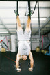 The sportsman the guy, carries out difficult exercise, sports gy