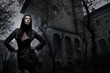 Fashion shoot of a young and sexy brunette in a dark dress