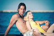 Photo: Happy couple relaxing at the beach. Happy couple relaxing at the beach.