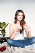 thoughtful young casual female with red flower