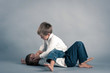 Two young brothers fighting.