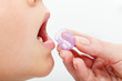 Child receiving homeopathic medication granules