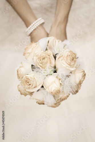 Photo: beauty wedding bouquet of roses in a bride hands beauty wedding bouquet of roses in a bride hands