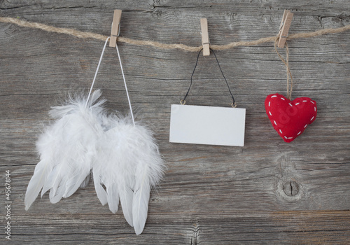 Photo: Angel wings with heart and blank note Angel wings with heart and blank note