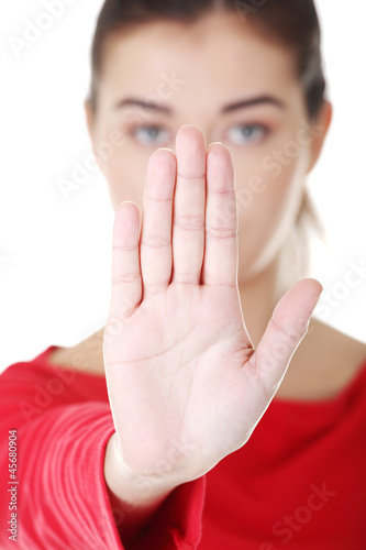 Photo: Confident woman making stop gesture sing Confident woman making stop gesture sing