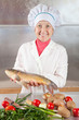 Photo: Cook woman with carp fish Cook woman with carp fish