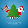 santa and reindeer behind christmas tree