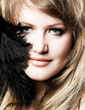 young girl with a feather near her face