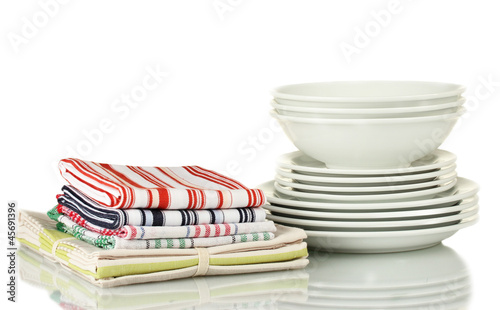 Photo: Kitchen towels with dishes isolated on white background Kitchen towels with dishes isolated on white background