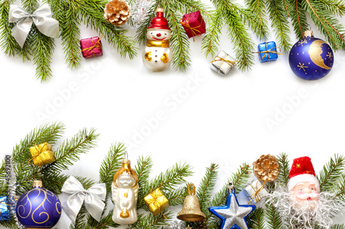 Photo: Christmas background border with fir and baubles on white Christmas background border with fir and baubles on white