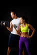 Couple doing dumbbell lifts