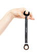 Foto: new wrench in female hand. new wrench in female hand.