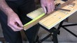 Man drawing a line and cutting a piece of wood with a saw