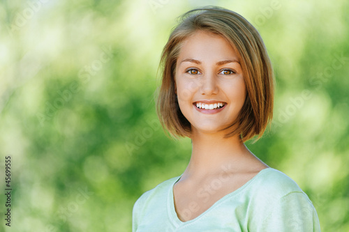 Photo: smiling beautiful young woman close up smiling beautiful young woman close up