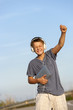 Cute boy dancing to the rhythm outdoors.