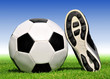 soccer ball and shoes in grass