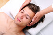 Handsome man enjoying face massage