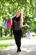Woman with shopping bags in the park