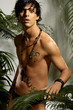 Photo: Young male model with gecko in tropical green forest background Young male model with gecko in tropical green forest background