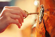 Hand inserting golden key in keyhole to open lock