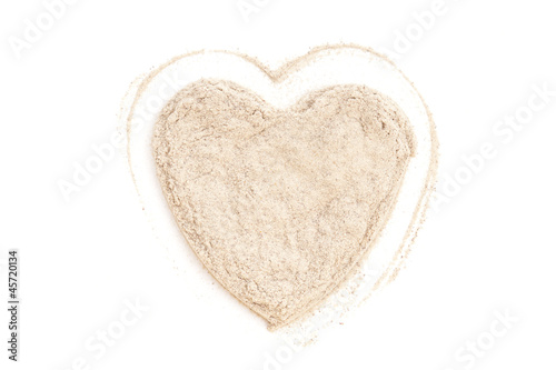Photo: Heap ground White Pepper isolated in heart shape on white backgr Heap ground White Pepper isolated in heart shape on white backgr