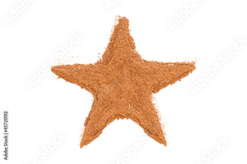 Photo: Heap of ground Cinnamon isolated in star shape on white backgrou Heap of ground Cinnamon isolated in star shape on white backgrou