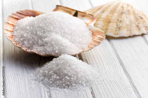 Photo: white crystal salt in seashell white crystal salt in seashell
