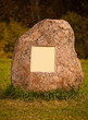 Big granite rock with empty metal plate