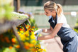 young female florist working in nursery