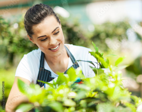 Photo: pretty young woman gardening pretty young woman gardening