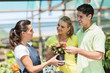 young couple buying flowers in nursery