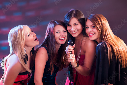 Photo: Four beautiful girls singing karaoke Four beautiful girls singing karaoke