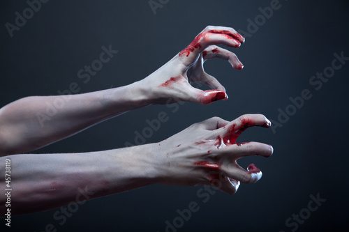 Photo: Zombie stretching bloody hands Zombie stretching bloody hands