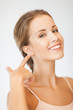 woman pointing to ear