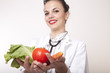 Photo: Beautiful young female doctor with vegetables Beautiful young female doctor with vegetables
