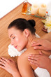Photo: Relaxed beautiful young woman having a spa massage on her back Relaxed beautiful young woman having a spa massage on her back