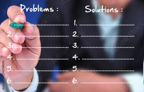 Photo: business man writing problem and solution business man writing problem and solution