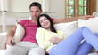 Couple Watching TV On Sofa