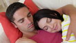 Couple Relaxing On Sofa Together