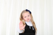 Little girl shows stop sign by opened palm to camera