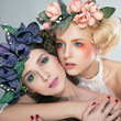 사진:Two pretty girls blonde and brunette in colored wreaths hugging Two pretty girls blonde and brunette in colored wreaths hugging