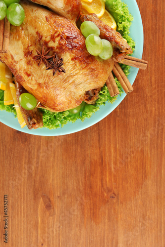 Photo: whole roasted chicken with lettuce, grapes, oranges and spices whole roasted chicken with lettuce, grapes, oranges and spices