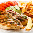 Grilled steaks, French fries and vegetables