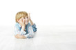 Photo: Little boy lying down on floor and looking up to the side Little boy lying down on floor and looking up to the side