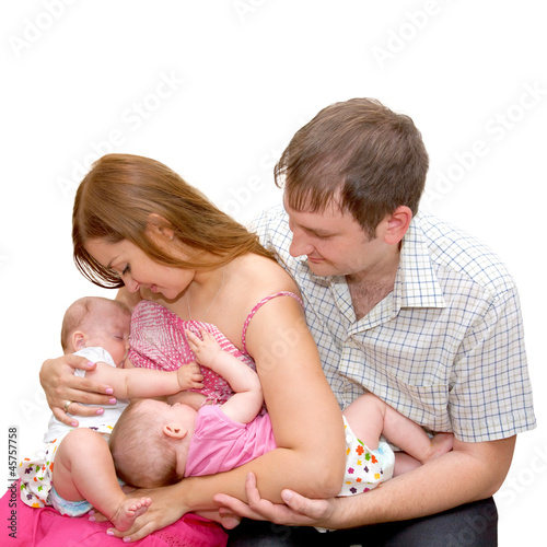 Photo: Breast feeding two little sisters twins Isolated on white Breast feeding two little sisters twins Isolated on white