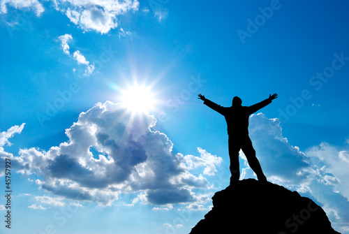 Photo: Man on peak of mountain. Man on peak of mountain.